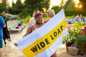 Weight Stigm [Image description: larger black woman holding towel that says "wide load"]