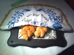 eating disorders in the Orthodox Jewish community [image description: two loaves of challah under an embroidered cover]