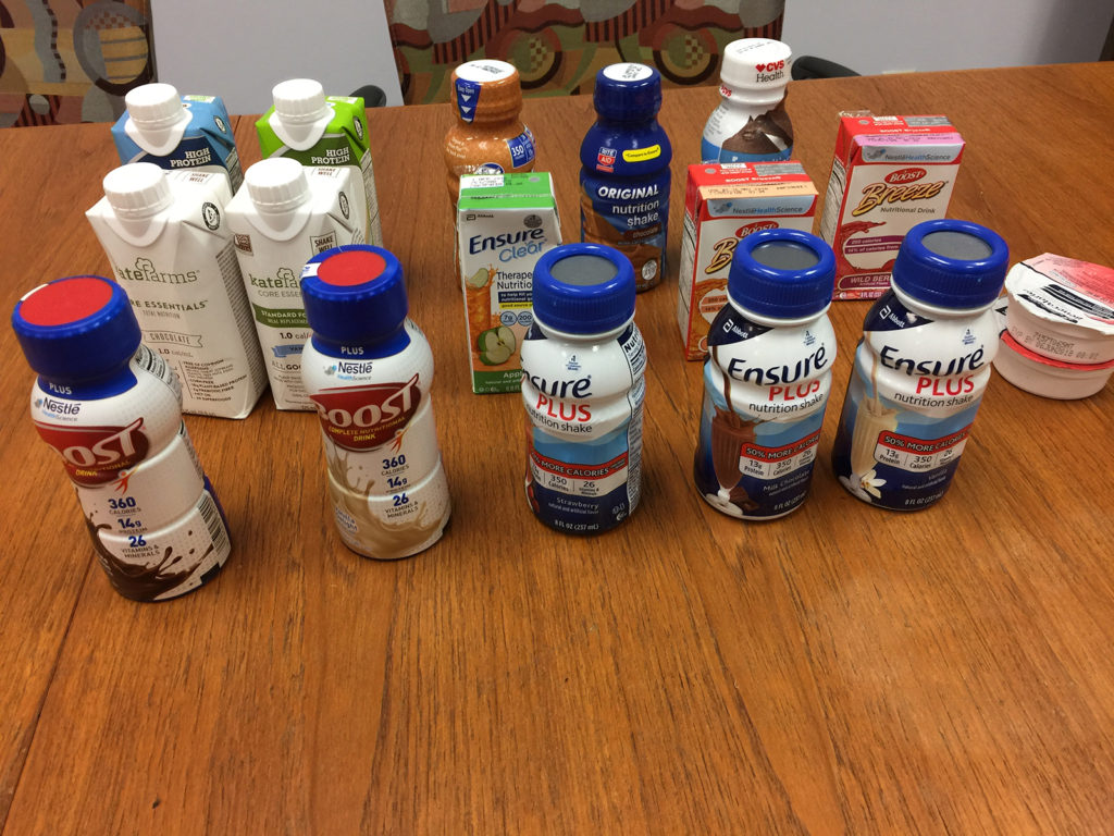 Nutritional supplements in eating disorder recovery - shakes [image description: assortment of supplemental shakes on a table]