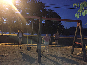 Empowering Parents [image description: kids swinging on swing set at night]