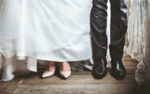Sweating for the Wedding? Say: I Don’t. [image description: legs of a bride and groom standing side by side]